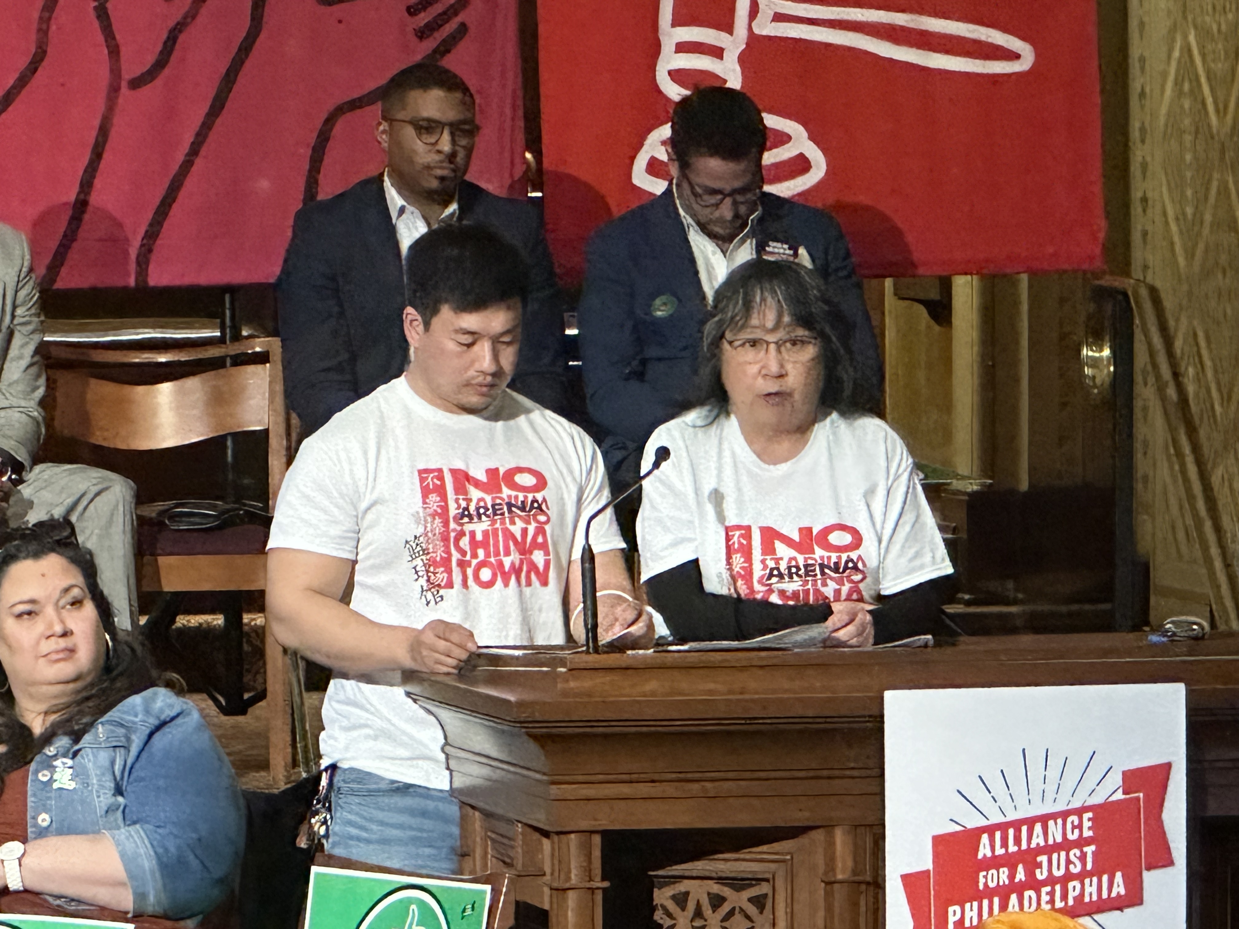 Debbie Wei and Wei Chen of Asian Americans United take the podium