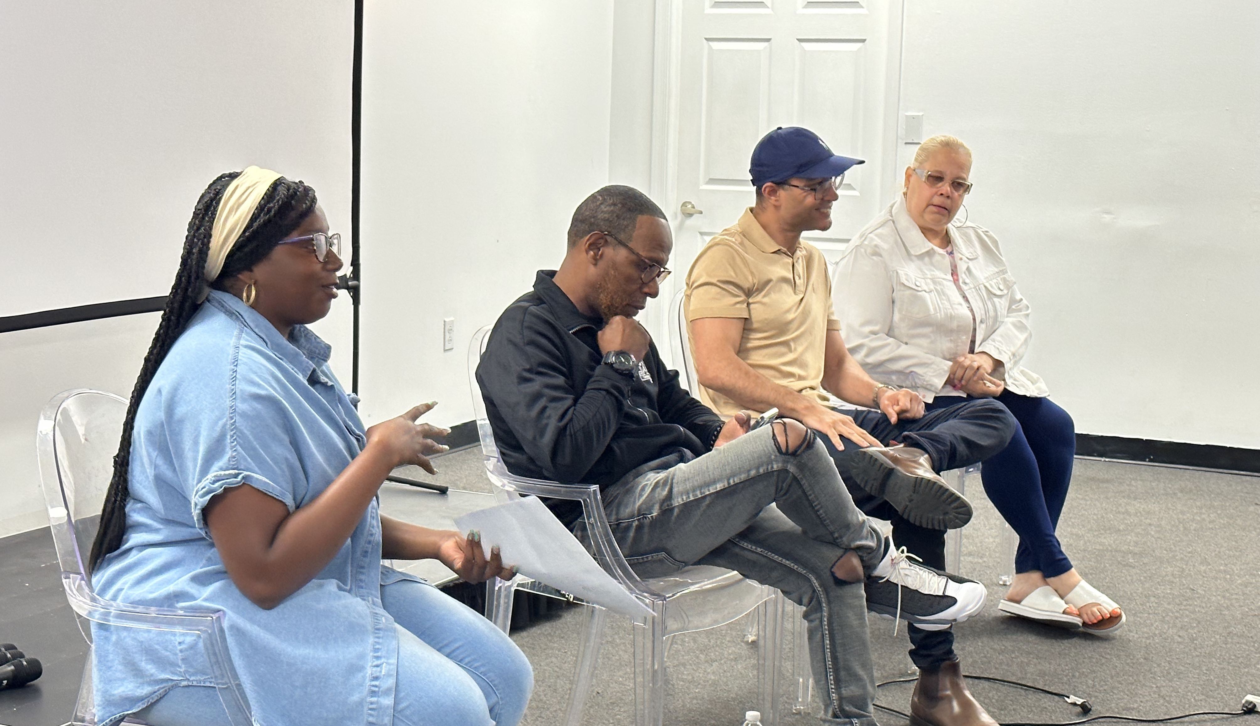 Dyamond speaks on a panel while Johnathan King, Mrs Dee Dee and Robert Holbrook sit next to her