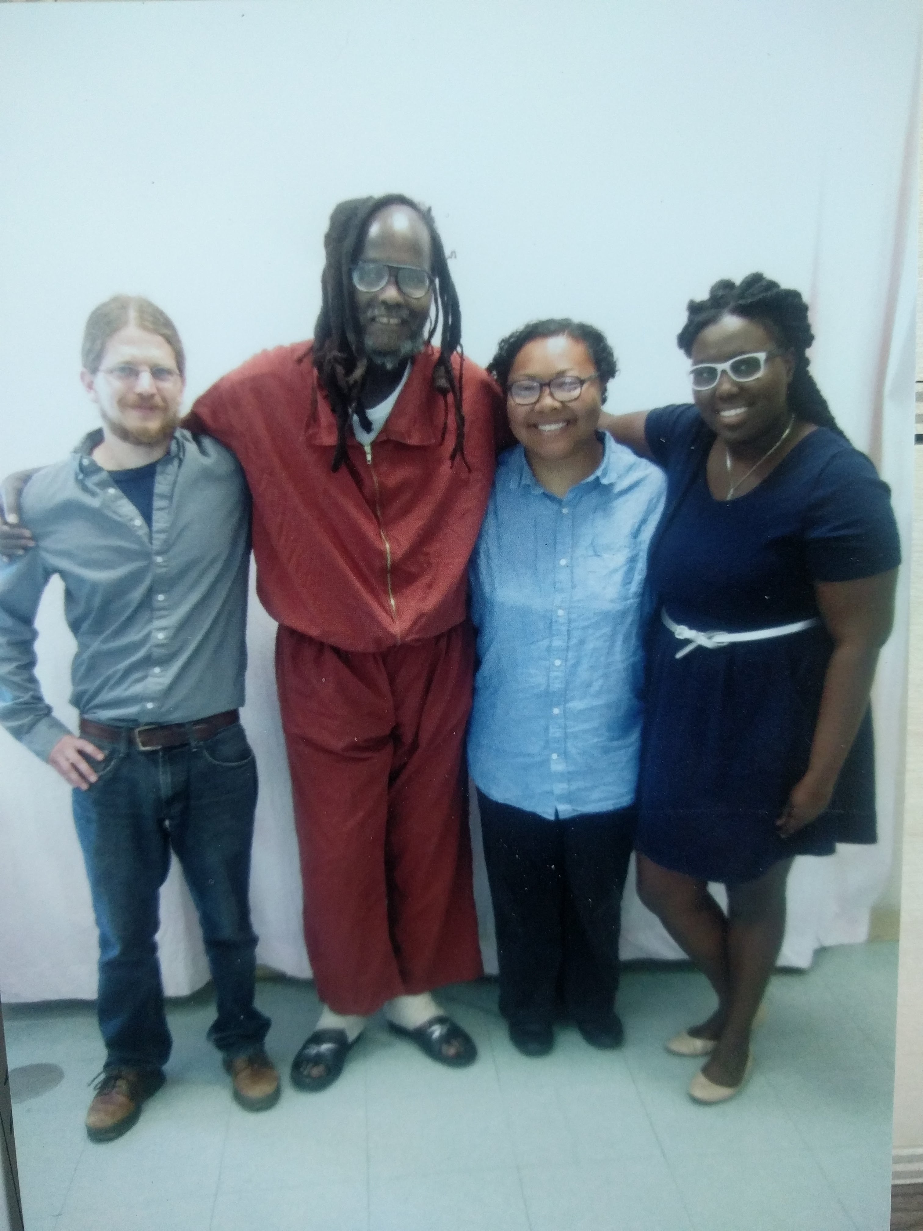 Kris Henderson and Nikki Grant of Amistad Law Project and Bret Grote of Abolitionist Law Center post for a picture during a legal visit with Mumia Abu-Jamal