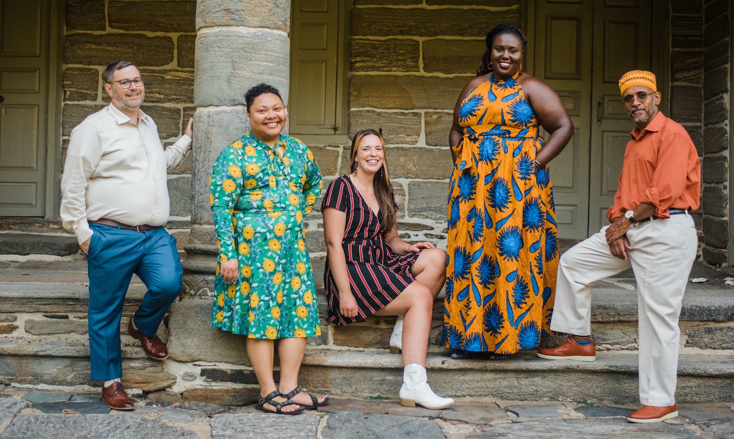 Amistad Law Project stands in front of a stone building