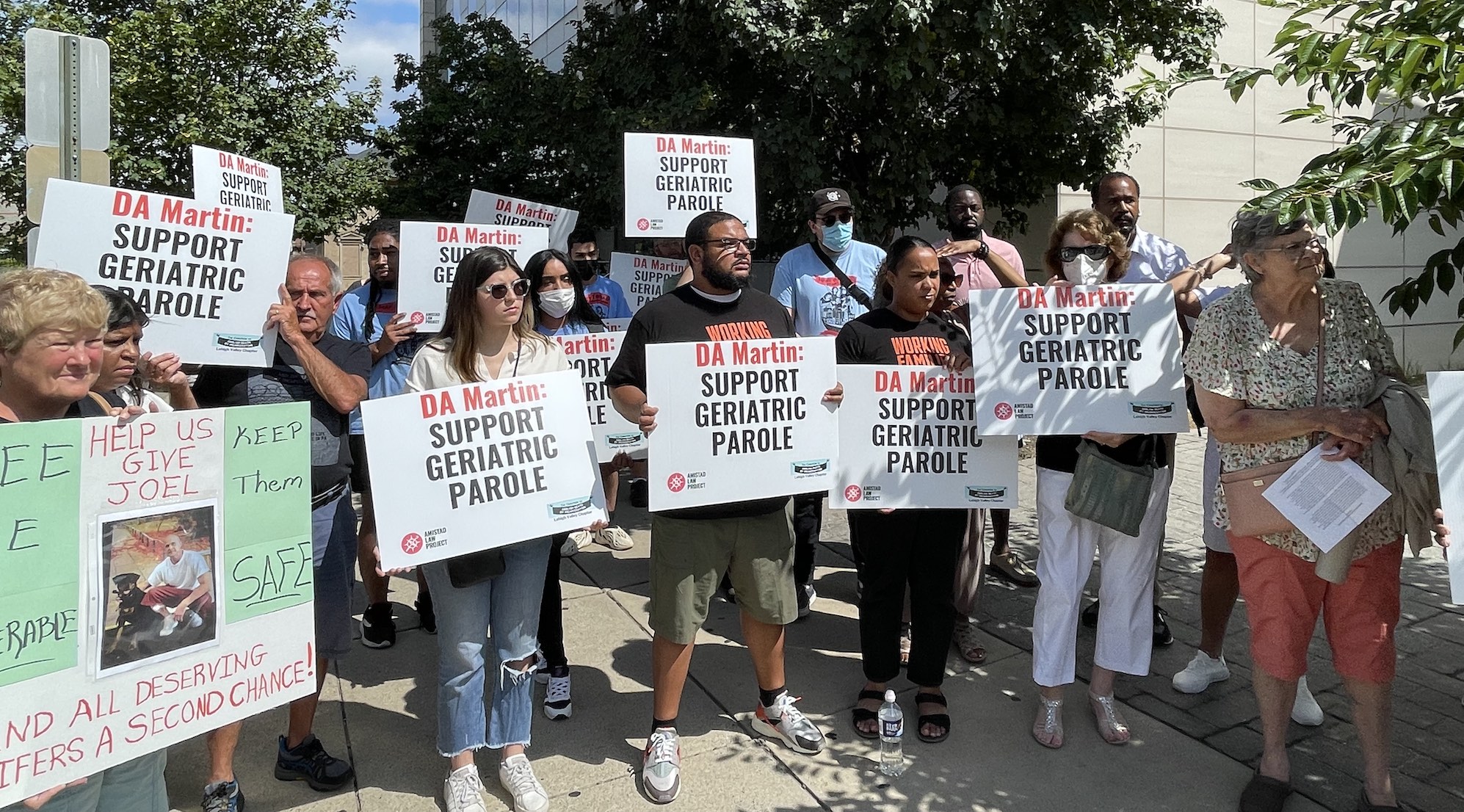 a crowd gathers to call on DA Jim Martin to support geriatric parole