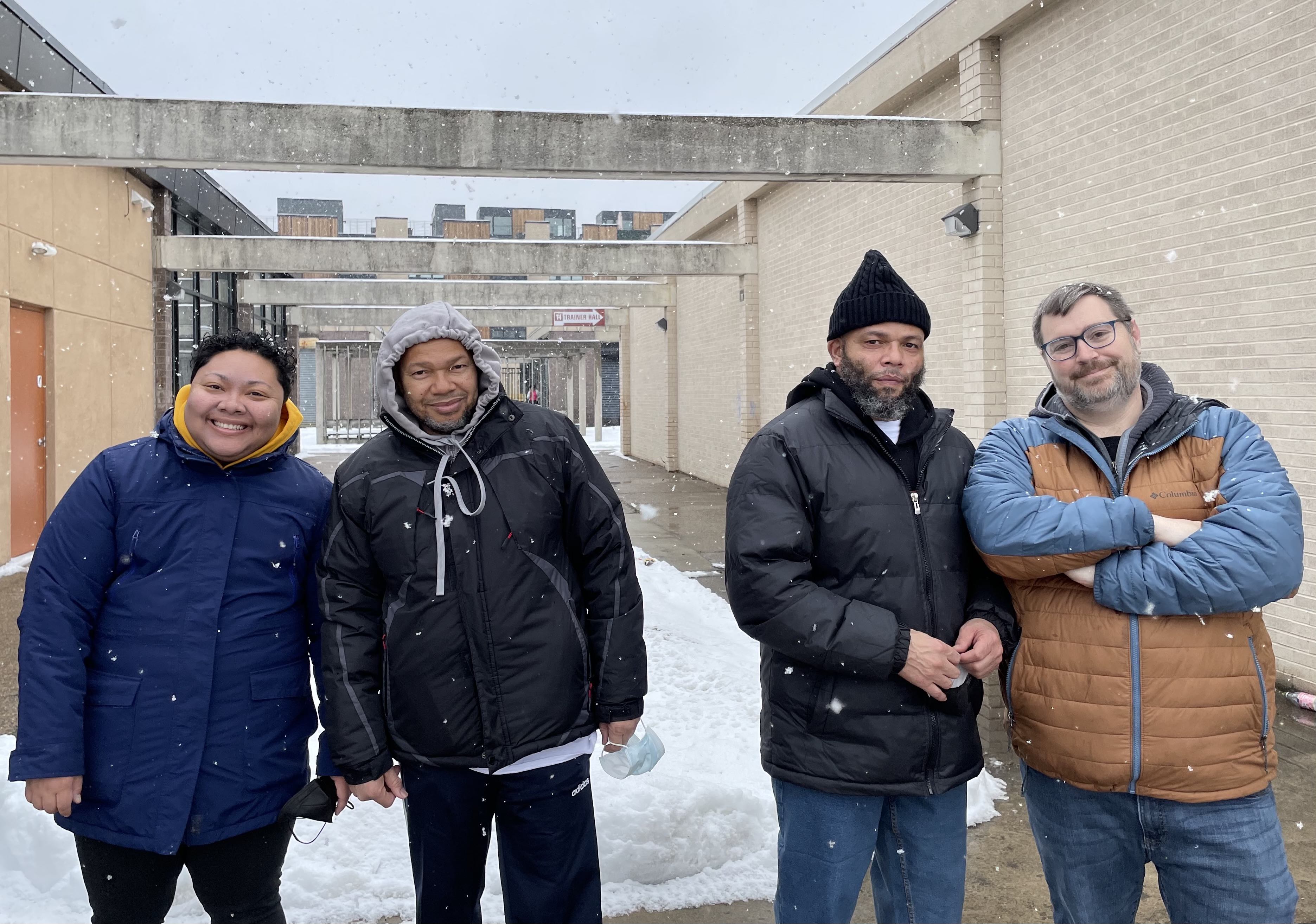 The Evans brothers take a picture with Kris Henderson and Sean Damon of Amistad Law Project as they hang out for the first time after being released from prison