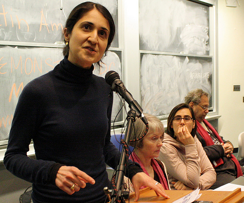 Pardiss speaks into a microphone during a panel event