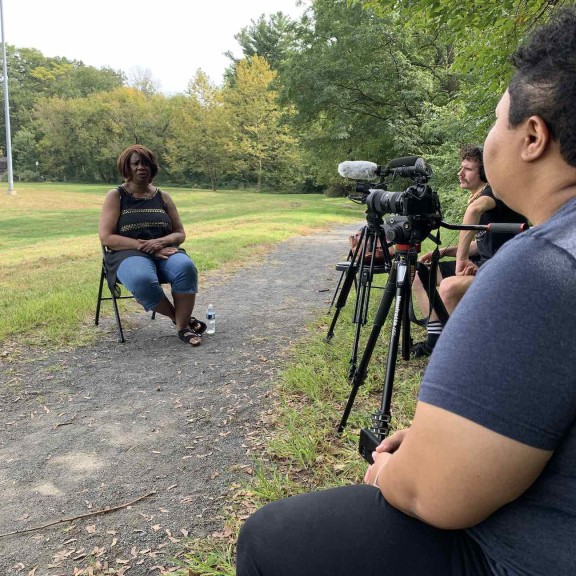 Kris Henderson of Amistad Law Project interview Yvonne Newkirk with a film crew from Bonfire Media Collective 