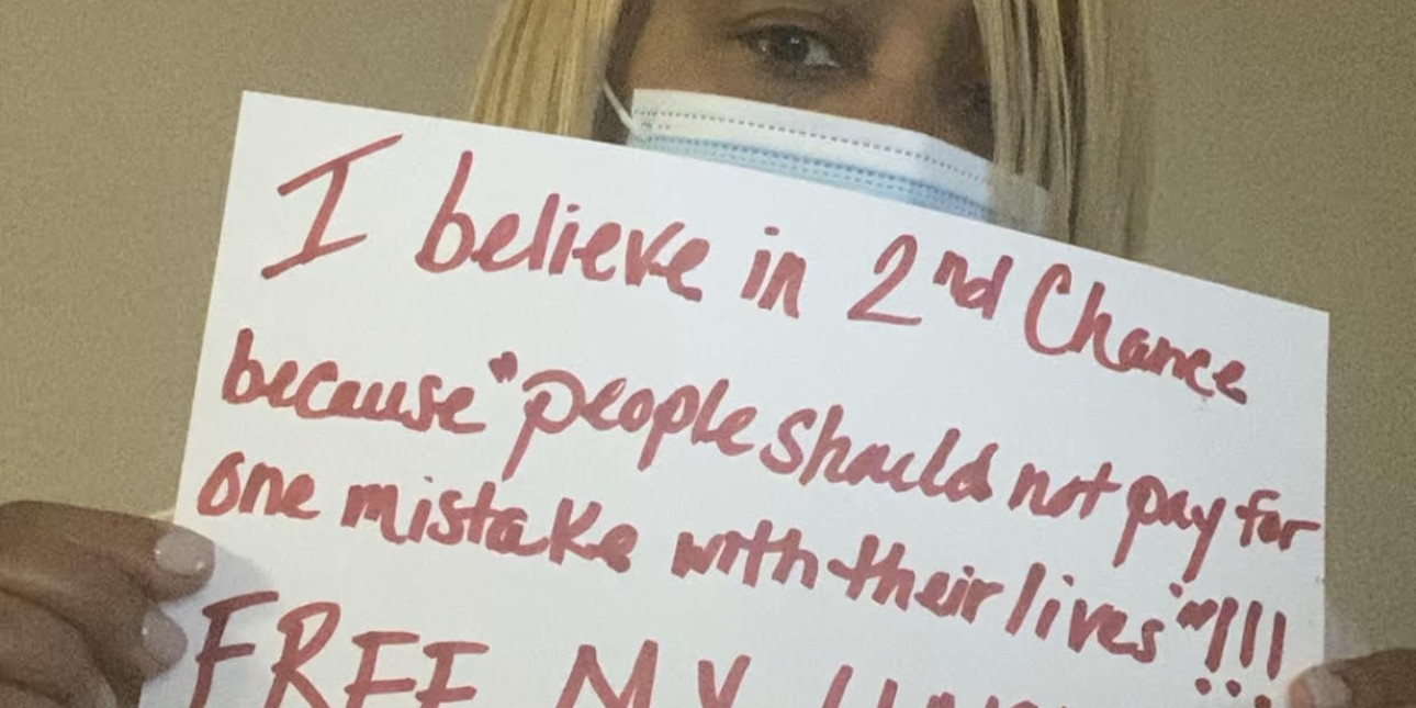 A member of Free Them to Heal US holds a sign that says 'I believe in 2nd Chance because people should pay for one mistake with their lives!! Free My Uncle. 38 years is too long!!!