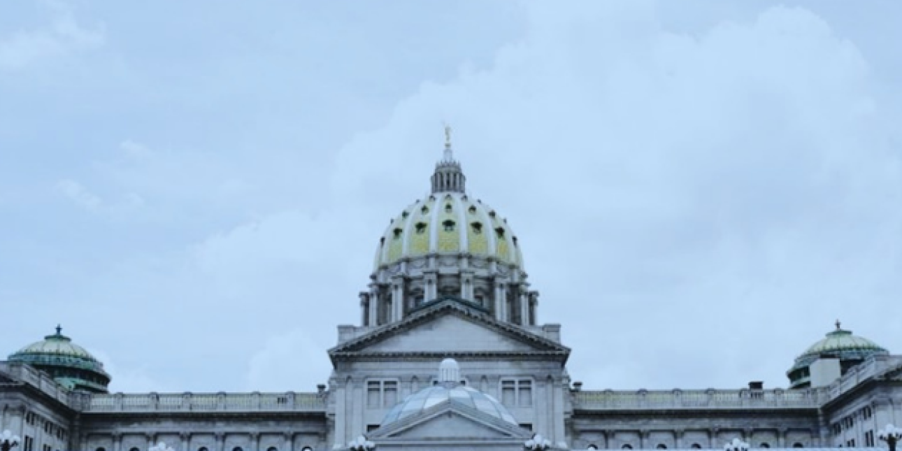 The dome of the PA state capitol is visible against a grey sky