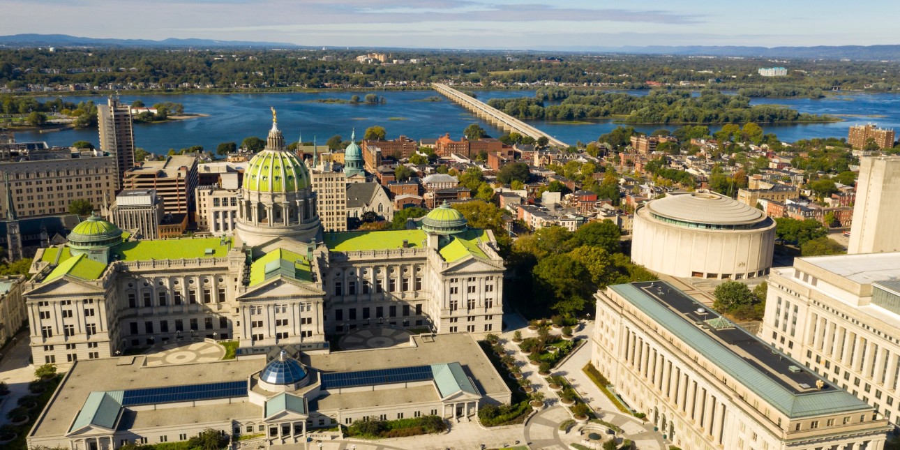 An image shows the green roof of the Harrisburg capitol from above