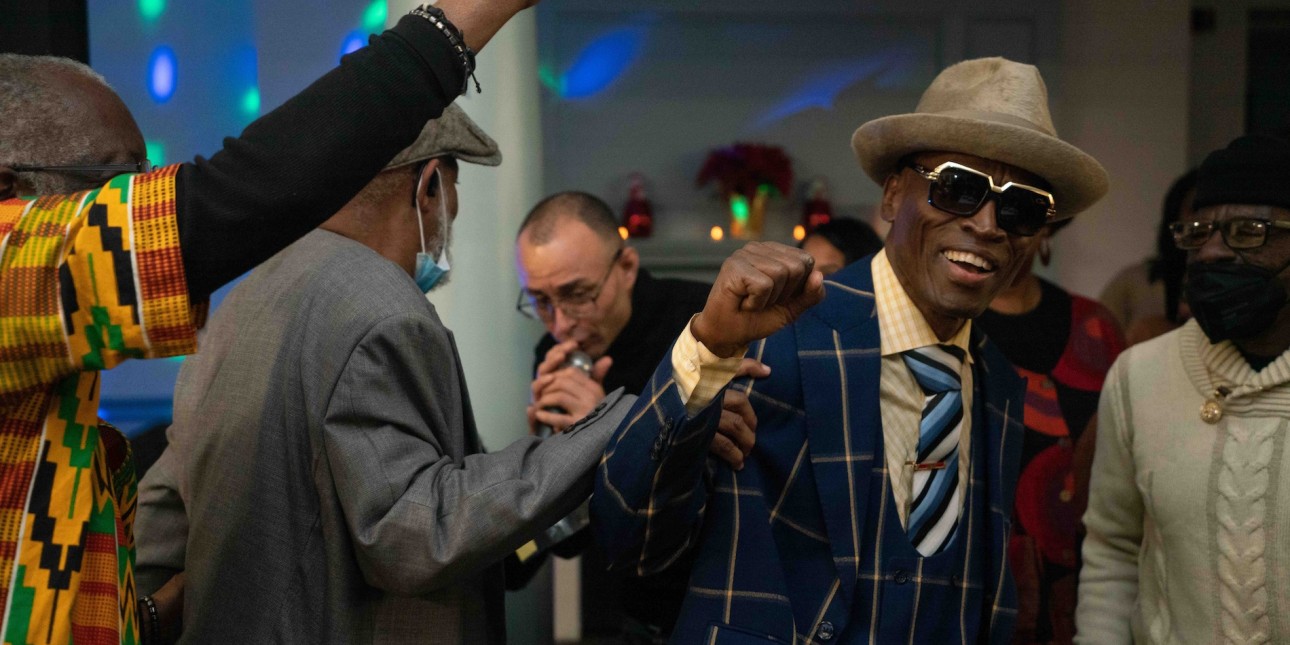 Blue and others dance at the Decarcerate and Be Merry Movement Holiday Party 