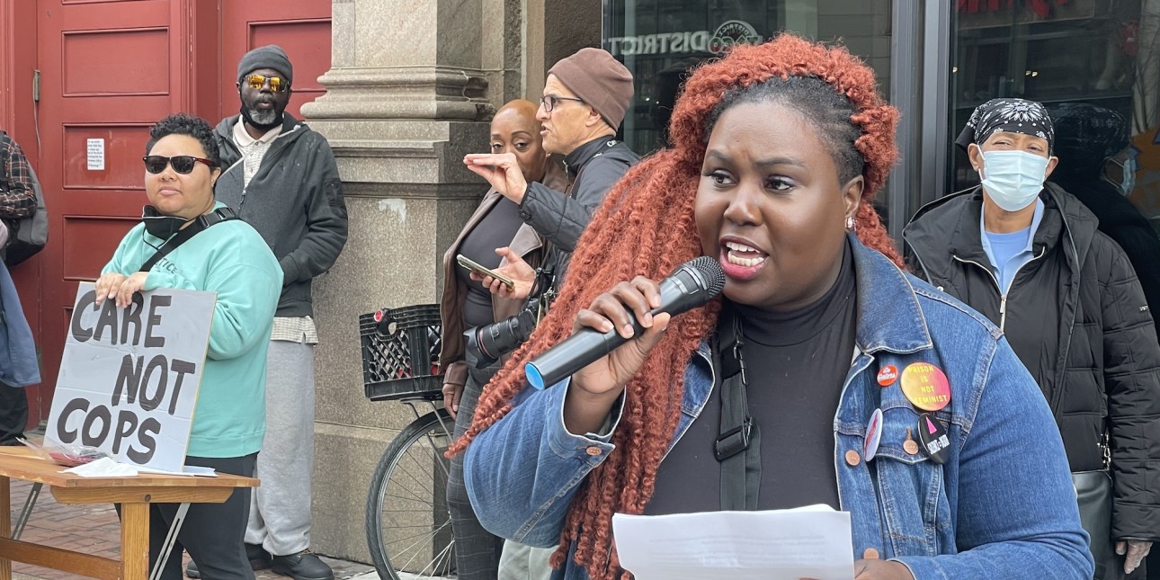 nikki holds the mic and speaks at a rally