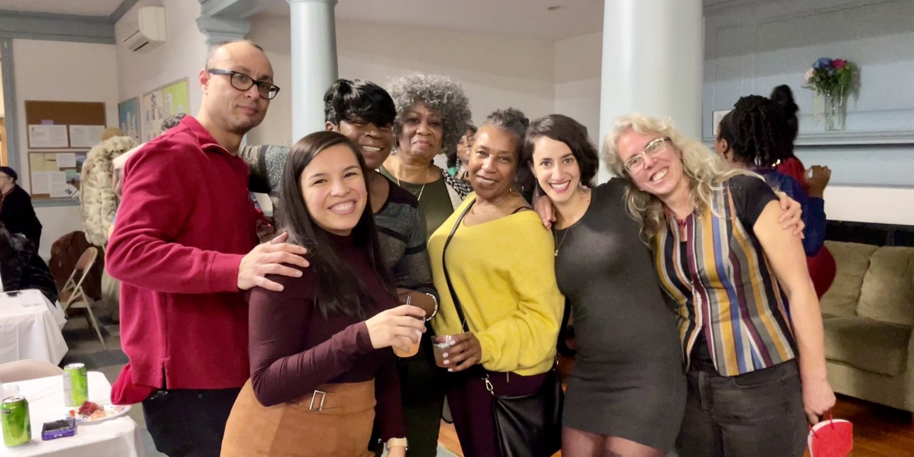 Friends huddle together at our movement holiday party