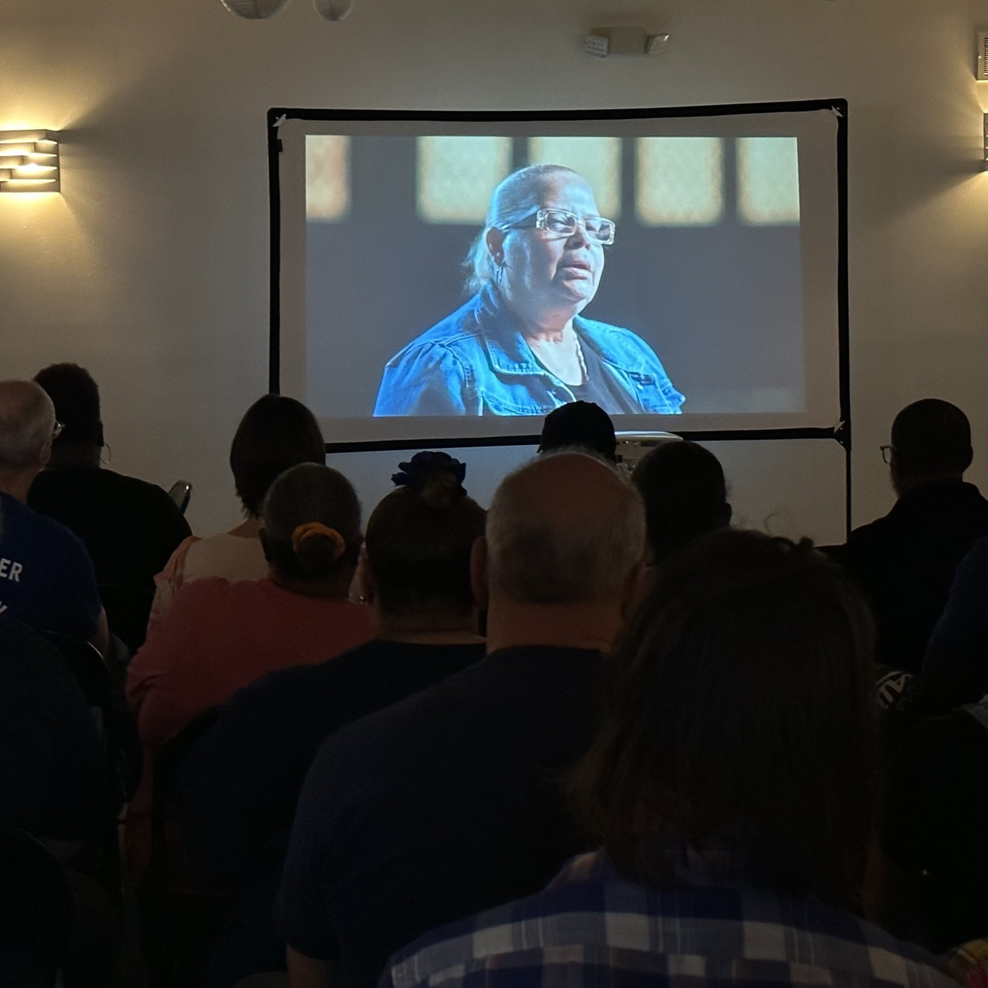 A photo shows a community screening in Delaware County
