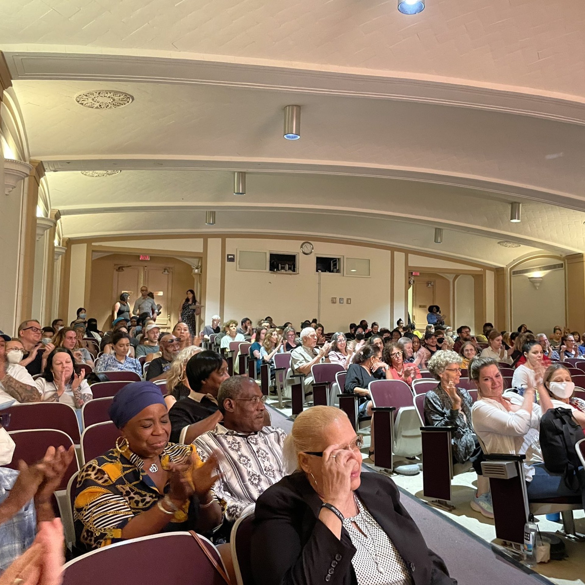 a photo shows a packed auditorium at the Philadelphia free library