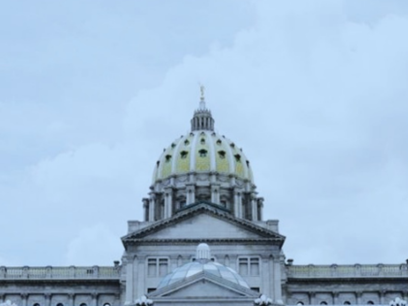 The dome of the PA state capitol is visible against a grey sky