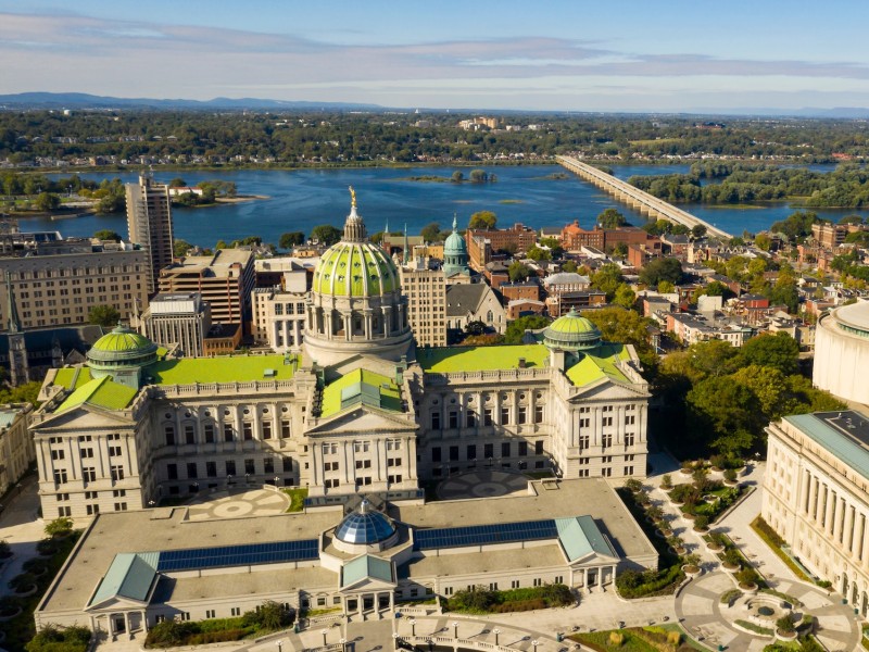 An image shows the green roof of the Harrisburg capitol from above