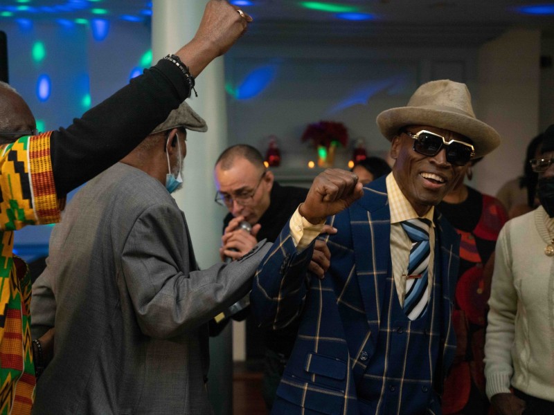 Blue and others dance at the Decarcerate and Be Merry Movement Holiday Party 