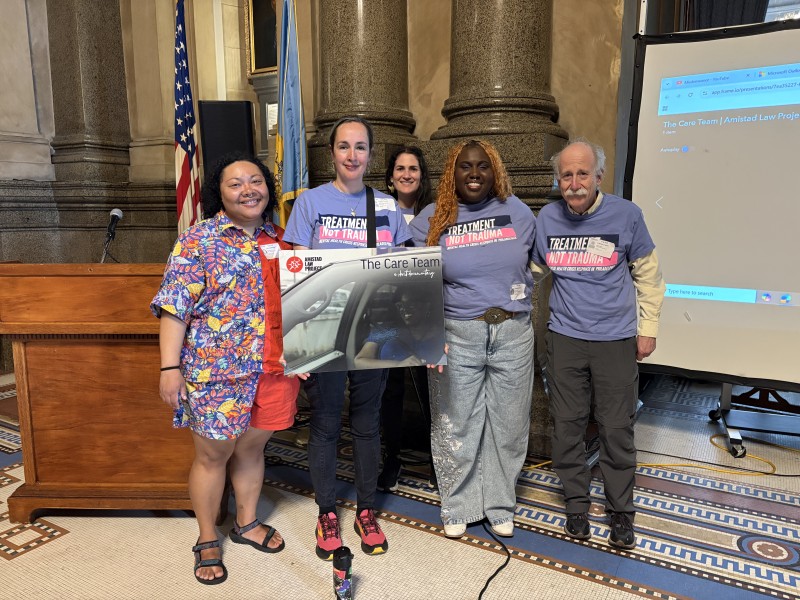 Members of Philadelphia Treatment Not Trauma hold Care Team poster