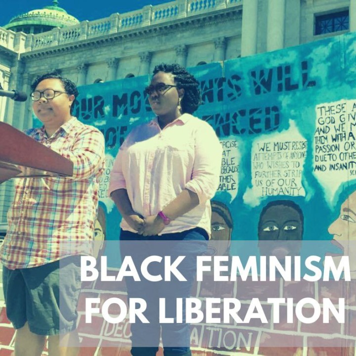 Kris Henderson and Nikki Grant stand at a podium with the words Black Feminism for Liberation underneath