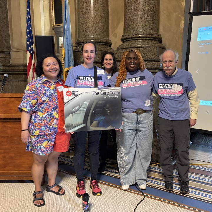 Members of Philadelphia Treatment Not Trauma hold Care Team poster